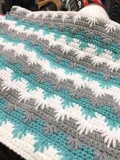 a crocheted blanket sitting on top of a table