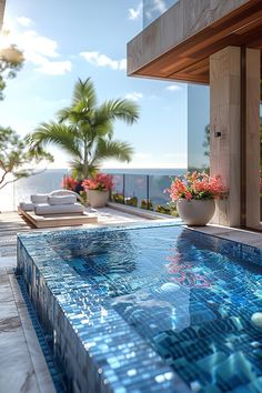 an outdoor swimming pool next to the ocean