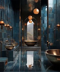 a large bathroom with blue tiles and gold fixtures on the walls, along with two sinks