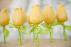 small yellow flowers with green stems on a table