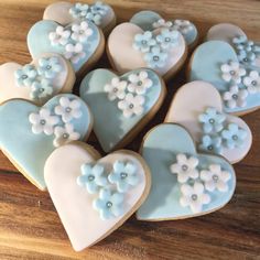 heart shaped cookies decorated with blue and white frosting