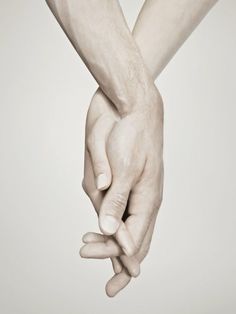 two hands holding each other over a white background