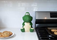 cookie cookies are sitting on the counter next to a frog figurine and an oven