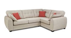 a beige sectional couch with red pillows on it