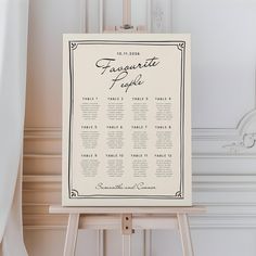 a white table plan sitting on top of a wooden easer