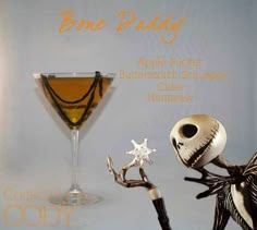 a halloween cocktail with a skeleton holding a spooky starfish in it's hand