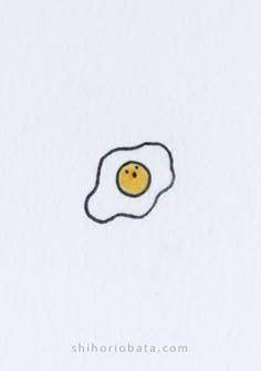 an egg with a smiley face drawn on it's side in the middle of white paper