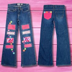 Lovingly refashioned Oshkosh jeans patched in shades of bright pink. These flare-leg bootcut jeans feature polka dot, heart design, and paisley fabric along with applique flowers for endless eye-catching fun. The flared bootcut leg and classic 5 pocket styling ensure all-day playtime comfort. Upcycled from an existing pair, the faint vintage wash finish gives off a pre-loved retro vibe she'll love to flaunt. Pair with her favorite graphic tees or flowing boho tops to complement the funky upcycled patches.  Size tagged: Girl's 10** Medium wash denim blue Distressed | Bootcut Fashioned with patches - Pink, purple Appliqued with multicolor flowers Patched  | Stitching Inseam about 24" Waist circumference measures about 25" adjustable Rise in front about 8" 99% cotton | 1% spandex Machine wash Patched Flare Jeans, Funky Upcycle, Pink Heart Jeans, Pink Jeans With Hearts, Retro Medium Wash Jeans With Patches, Heart Patches On Jeans, Patched Jeans Diy, Refashion Jeans, Dot Heart