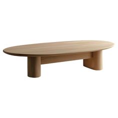 an oval wooden table sitting on top of a white wall