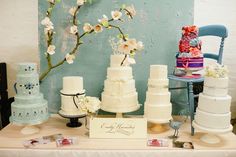 a table topped with lots of different types of cakes