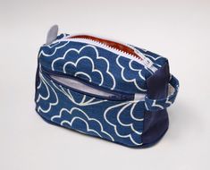 a blue and white bag with an orange lining