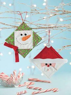 two christmas ornaments hanging from a tree