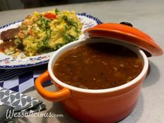 a bowl of soup and a plate of food on a table