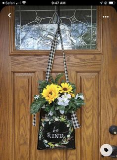 a door hanger that has sunflowers in it