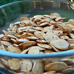 a blue bowl filled with almonds on top of a wooden table