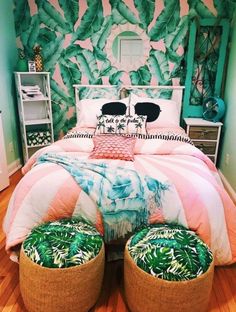 a bed with two foot stools in front of it and a green wall behind it