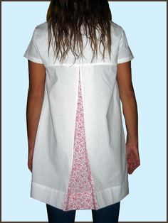 the back of a woman's white shirt with pink flowers on it