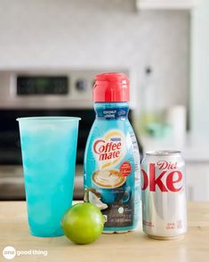 an apple, coffee mate and diet coke sitting on a kitchen counter