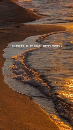 the sun is setting on the beach with waves coming in from the water and sand