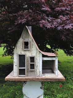 a small house made out of an old piece of wood