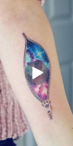 a woman's arm with a tattoo on it and an image of a star in the sky