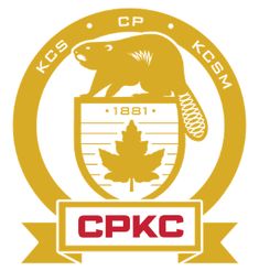 the kcs logo is shown in yellow and red, with a bear on it's chest