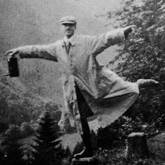 an old black and white photo of a man with his arms outstretched in the air