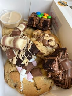 a box filled with lots of different types of cookies and desserts on top of it