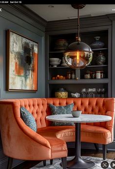 an orange couch and two chairs in a room