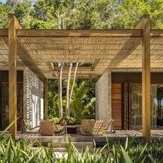 an outdoor covered patio with wicker furniture