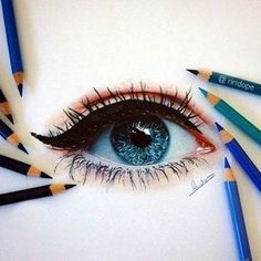 a drawing of an eye with colored pencils around it and the eyes are blue