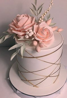 there is a white cake with pink flowers on it