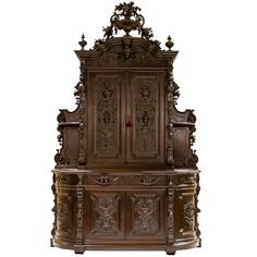 an ornate wooden cabinet with carvings on it