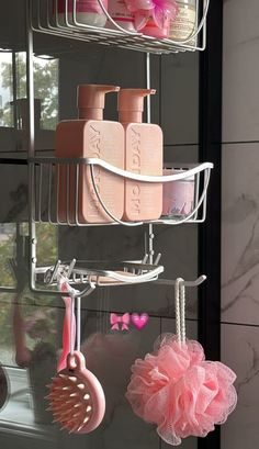 bathroom accessories are hanging on the wall in front of a window with pink and white decorations