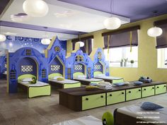 the children's room is brightly decorated with blue and green walls, windows, and built - in beds