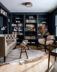 a living room filled with furniture and bookshelves