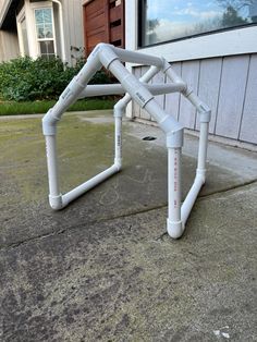 a white metal structure sitting on the side of a building