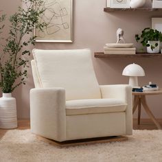 a white chair sitting on top of a rug in a living room