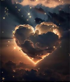 a heart - shaped cloud in the sky with stars around it is illuminated by sunlight