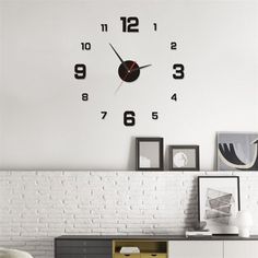 a large clock on the wall above a dresser in a room with white brick walls