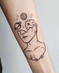 a person with a tattoo on their arm that has an image of a man's face and planets