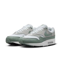 The Nike Air Max 1 'White Mica Green' is the perfect combination of style and comfort. Its simple and generous silhouette design gives a casual and fashionable style. The lightweight and comfortable design allows for flexible and effortless movement, making it perfect for everyday wear. The inspiration behind the design is to provide a unique and modern look that stands out from the crowd. The White/Mica Green/Photon Dust/Black colorway is perfect for any occasion and adds a touch of class to an Tinker Hatfield, French Architecture, Nike Models, Nike Air Max 1, Mens Nike Air, Grey Suede, Air Jordan 1 Mid, Nike Store, White Mesh