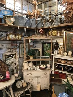 a room filled with lots of different types of furniture and decor on top of shelves