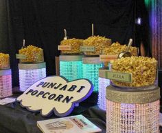 a table topped with lots of popcorn covered in lights