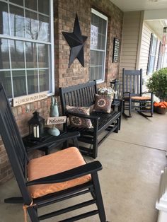 the porch is decorated with rocking chairs and pillows