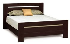 a bed with a wooden headboard and foot board, made in dark brown wood