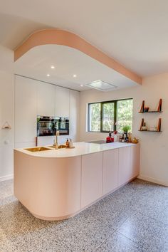 a large kitchen with two sinks and an island in the middle of the room,