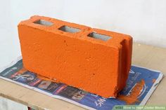 an orange brick sitting on top of a wooden table