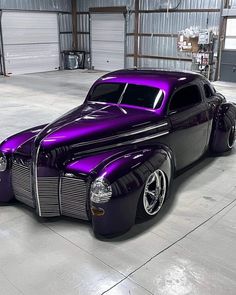 a purple and black car parked in a garage