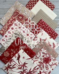 many different types of fabric on a wooden surface with the words ella type quilt shop